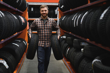 Wall Mural - Man chooses winter car tires in the auto shop