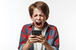 A kid screams emotionally into smartphone isolated on a white background