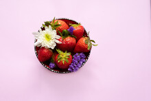 Fresh Wild Strawberries And Flower In Bowl On Table, Closeup