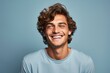 © MediaRaw - A man with a blue shirt is smiling and looking at the camera