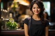 © Алина Бузунова - Portrait of happy asian woman standing at doorway of cafe or restaurant