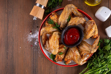 Grilled roasted spicy chicken wings with ketchup