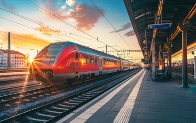 Wall Mural - A red train is sitting on the tracks at a train station