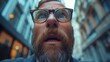 Shocked Bearded Man in Glasses Looking Upwards in Urban Setting