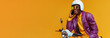 funny and loud young african man, he is on the phone and riding a fast scooter at the same time, he is wearing modern yellow and purple casual clothes and a scooter helmet, plain yellow background