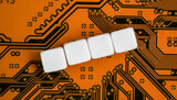 Fototapeta Sawanna - Electronic orange printed circuit board, with four empty white beads small cubes, detail view from above