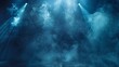 A dramatic blue spotlight illuminates smoke on a stage