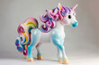 Unicorn sculpture art toy in the rainbow color on white background