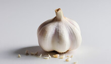 A Single White Garlic Bulb Placed On A Plain White Surface, Creating A Minimalist And Clean Composition