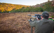 Man shoots rifle with optics at shooting range before hunting.