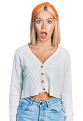 Canvas Print - Beautiful young blonde woman wearing casual white sweater afraid and shocked with surprise and amazed expression, fear and excited face.