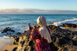 © ADDICTIVE STOCK - Muslim Woman Enjoying Music on a Sunny Beach