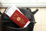 Fototapeta  - Japan passport with airline tickets on touristic backpack close up. Tourism and travel concept