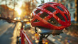 A red bicycle helmet and a part of a bike handle during sunset.