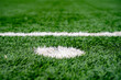 Penalty point on artificial grass football pitch.