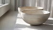 Three white bowls on a tablecloth