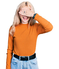 Wall Mural - Young caucasian woman wearing casual clothes smiling and laughing with hand on face covering eyes for surprise. blind concept.