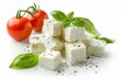 Traditional Greek homemade feta cheese cubes with rosemary olives and olive oil sauce displayed in a white bowl on a light gray background