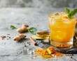 Turmeric ginger lemon and honey tonic on concrete