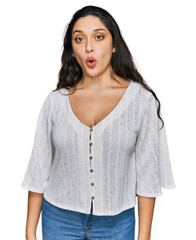 Wall Mural - Brunette young woman wearing casual clothes afraid and shocked with surprise expression, fear and excited face.