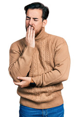 Wall Mural - Young hispanic man wearing casual clothes bored yawning tired covering mouth with hand. restless and sleepiness.