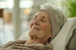 © StockUp - A capture of an elderly individual taking a restful nap in a well-lit, cozy room, symbolizing peace and contentment