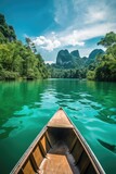 Fototapeta Do pokoju - A small boat is floating on a river with a beautiful view of mountains in the background. The water is calm and clear, and the boat is the only thing visible in the scene