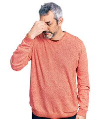 Canvas Print - Middle age hispanic with grey hair wearing casual sweater tired rubbing nose and eyes feeling fatigue and headache. stress and frustration concept.