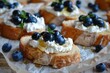 Ricotta cheese blueberry and honey crostini on paper