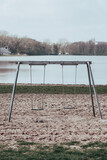 Fototapeta Dmuchawce - empty swing in the park