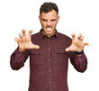© Krakenimages.com - Young hispanic man wearing casual clothes smiling funny doing claw gesture as cat, aggressive and sexy expression