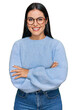 © Krakenimages.com - Young hispanic woman wearing casual clothes and glasses happy face smiling with crossed arms looking at the camera. positive person.