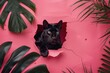 The face of a black cat is abstractly blurred out while standing amidst vibrant green tropical leaves