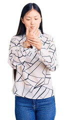 Sticker - Young beautiful chinese woman wearing casual shirt suffering pain on hands and fingers, arthritis inflammation