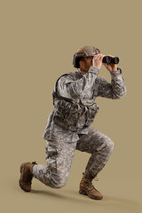 Wall Mural - Male soldier in uniform looking through binoculars on green background