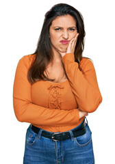 Sticker - Beautiful hispanic woman wearing casual clothes thinking looking tired and bored with depression problems with crossed arms.