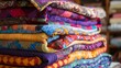 A stack of colorful quilts