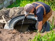 Man pumping out house septic tank. drain and sewage cleaning service