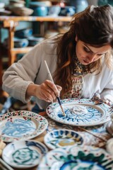 Poster - Woman painting on plate with brush. Suitable for art and creativity concepts
