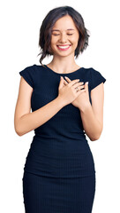 Wall Mural - Young beautiful girl wearing casual clothes smiling with hands on chest with closed eyes and grateful gesture on face. health concept.