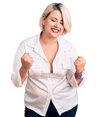 Wall Mural - Young blonde plus size woman wearing casual shirt very happy and excited doing winner gesture with arms raised, smiling and screaming for success. celebration concept.