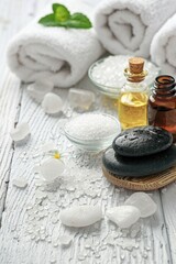 Poster - A stack of white towels on a wooden table. Perfect for spa or hotel concepts