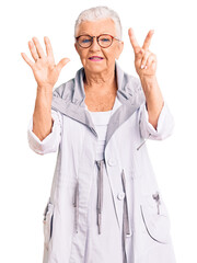 Wall Mural - Senior beautiful woman with blue eyes and grey hair wearing casual clothes and glasses showing and pointing up with fingers number seven while smiling confident and happy.