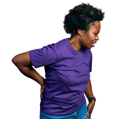 Wall Mural - African american woman with afro hair wearing casual purple t shirt suffering of backache, touching back with hand, muscular pain