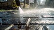 Cleaning the floor at the entrance of the house during the spring with a powerful jet of water. Water pressure to remove dirt and debris from the home's entrance paving.