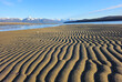 Sand patterns at the beach at low tide on a sunny day.