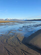Flowing sand patterns on a beach in Southeast Alaska on a sunny winter day at low tide.