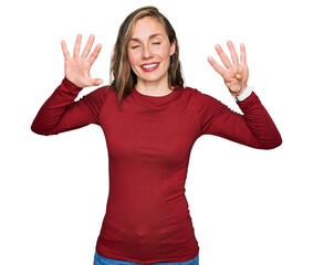 Canvas Print - Young blonde woman wearing casual clothes showing and pointing up with fingers number nine while smiling confident and happy.