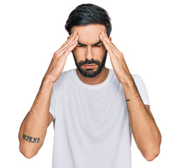 Sticker - Young hispanic man wearing casual white t shirt with hand on head for pain in head because stress. suffering migraine.