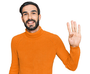 Wall Mural - Young hispanic man wearing casual clothes showing and pointing up with fingers number four while smiling confident and happy.